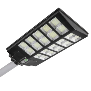 A rectangular LED streetlight with multiple LED panels mounted on a pole, emitting bright light.